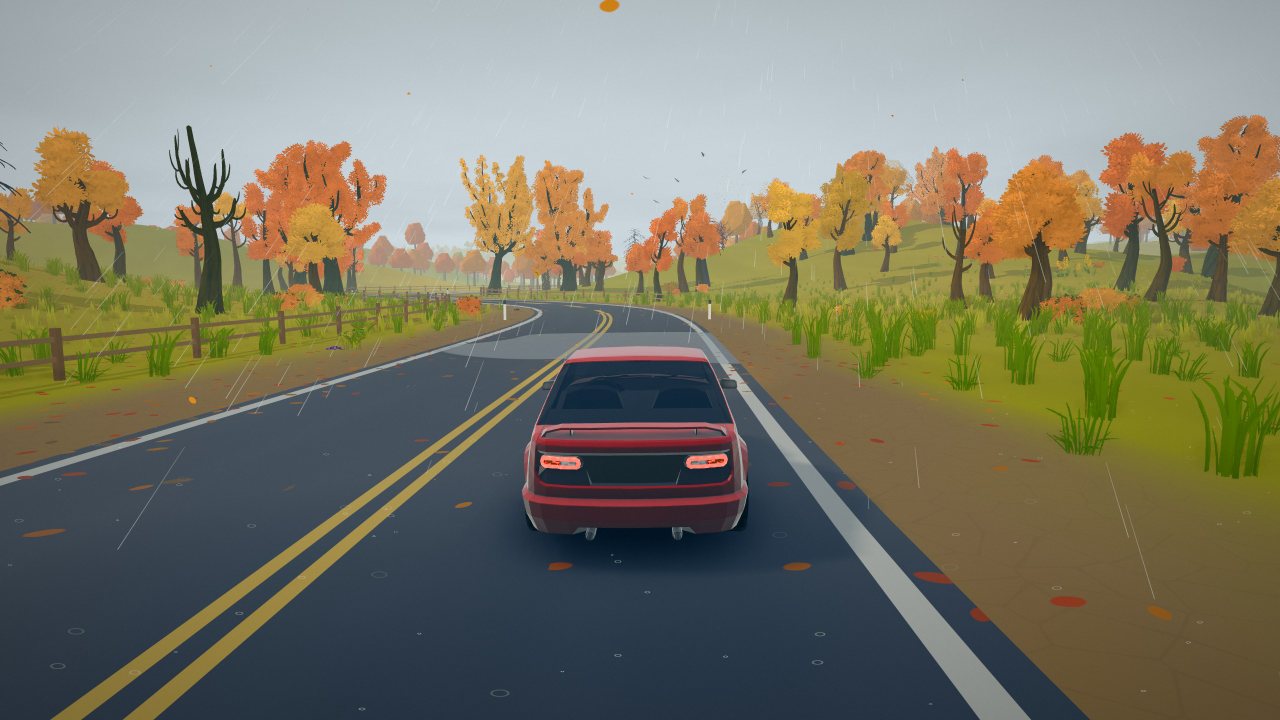 A wet road through autumn woods in the rain, orange and gold trees on both sides.